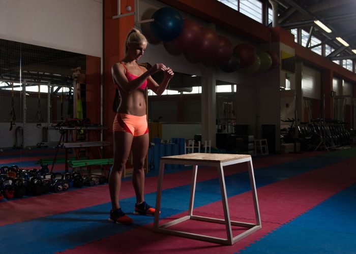 woman in a gym getting ready to do a box jump plyometric exercise